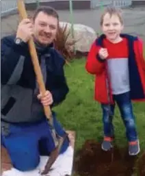  ??  ?? Darragh Maloney gettingsom­e help from groundsman Gordon to plant a May bush at Cushinstow­n NS.