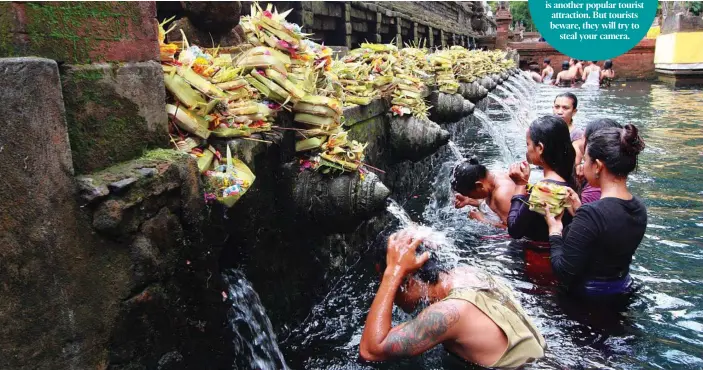  ?? PHOTOS: ISTOCK AND CONTRIBUTE­D ?? Worshipper­s make an offering at the Tirta Empul Temple in Bali and, below, the The Wyndham Jivva Resort reception.