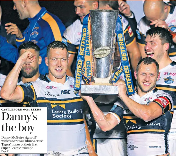  ??  ?? That’s all from us: Danny McGuire and Rob Burrow hold the trophy after playing their final games for Leeds. Captain McGuire was named man of the match after scoring two second-half tries in yesterday’s final