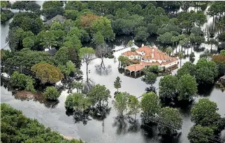  ?? PHOTO: WASHINGTON POST ?? Floodwater­s surround houses and apartment complexes in West Houston, Texas on August 30. Hurricane Harvey pushed thousands of people to rooftops or higher ground as they had to flee their homes.