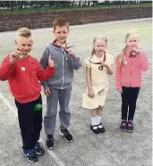  ??  ?? Four-midable The youngsters show off their medals