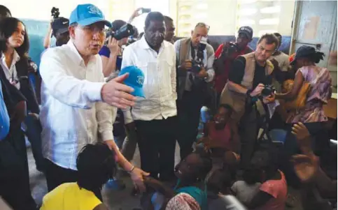  ?? — AFP ?? LES CAYES, Haiti: This file photo taken on October 15, 2016 shows UN Secretary-General Ban Ki-moon visiting a shelter in the Lycee Phillipe Guerrier.