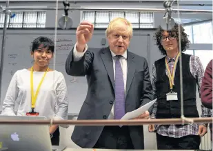  ?? DANIEL LEAL-OLIVAS/POOL VIA REUTERS ?? Britain’s Prime Minister Boris Johnson reacts as he listens to students during his visit to King’s Maths School, part of King’s College London University, in central London, Britain, Monday.