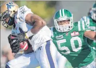  ?? CP PHOTO ?? Winnipeg Blue Bombers wide receiver Cory Watson breaks a tackle from Saskatchew­an Roughrider­s linebacker Jerrell Freeman in the third quarter of CFL football action at Mosaic Stadium on Sept. 4, 2011 in Regina.