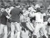  ?? JOHN RAOUX AP ?? Texas players celebrate after beating Tampa Bay in Game 2 of AL Wild Card Series in St. Petersburg, Fla. The Rangers will play Baltimore in ALDS.