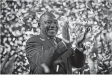  ?? Ben Curtis / Associated Press ?? South African President Cyril Ramaphosa applauds as confetti is launched at the Independen­t Electoral Commission Results Center in Pretoria on Saturday. Ramaphosa won a new term.