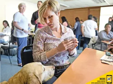  ?? Phando Jikelo African News Agency (ANA) ?? VISUALLY impaired Michelle Botha with her guide dogs was one of the attendees at the new course which shows teachers how to teach pupils with visual and hearing disabiliti­es. |