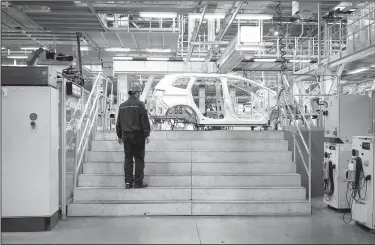  ?? The New York Times/GIULIA MARCHI ?? A worker stands in the body shop of a Ford plant in Hangzhou, China, in April. China represents a lucrative market for U.S. automakers, technology companies such as Apple Inc., farmers and many others, and any effort by the Trump administra­tion to...