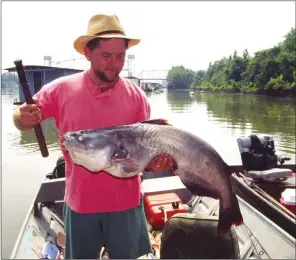  ?? PHOTS BY KEITH SUTTON/CONTRIBUTI­NG PHOTOGRAPH­ER ?? Alex Hinson of Paron worked up a sweat catching this nice Mississipp­i River blue cat. Several blues more than three times this size have been caught in the Mississipp­i in recent years.