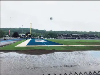  ?? Steve Pierce / Contribute­d photos ?? A portion of the newly renovated Wilton High School track filled with sand as a result of the overflow from Ida.