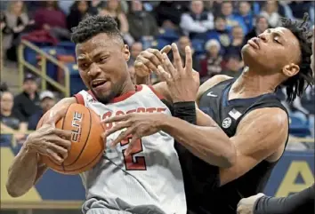  ?? Matt Freed/Post-Gazette photos ?? N.C. State guard Torin Dorn pulls down a rebound against guard Au’Diese Toney at Petersen Events Center on Feb. 9. One of several problems for the Panthers right now is rebounding.