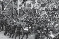  ??  ?? Trump supporters clash with police and security forces as they storm the US Capitol Jan. 6 in Washington. [GETTY IMAGES]