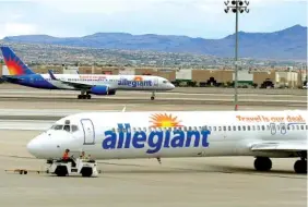  ?? ASSOCIATED PRESS FILE PHOTO ?? Two Allegiant Air jets taxi at McCarran Internatio­nal Airport in Las Vegas.