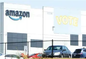  ?? AP PHOTO/JAY REEVES ?? A banner encouragin­g workers to vote in labor balloting is shown at an Amazon warehouse in Bessemer, Ala., on March 30.