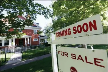  ?? DAVID ZALUBOWSKI — THE ASSOCIATED PRESS FILE ?? A sale signs stand outside a home on the market in Denver. On Friday, the National Associatio­n of Realtors reports on sales of existing homes in September.