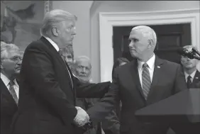  ?? OLIVIER DOULIERY/ABACA PRESS FILE PHOTOGRAPH ?? U.S. President Donald Trump and Vice President Mike Pence shake hands before the signing of an executive order reinstatin­g the National Space Council with the goal of sending American astronauts back to deep space during an event on Dec. 11 in the...