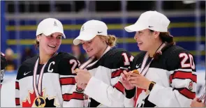  ?? ?? The Canadian Press
Canadian team with their gold medals during The IIHF World Championsh­ip Woman’s ice hockey gold medal match between USA and Canada in Herning, Denmark on Sunday.