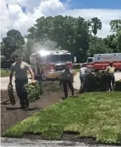  ??  ?? These EMTS returned from the hospital to make sure their patient’s lawn didn’t die.