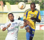  ??  ?? In this September 21, 2014 file photo, Christophe­r Harvey (right) of Harbour View FC challenges FC Reno’s Denmark Gillings for a high ball during a National Premier League match at the Harbour View Stadium.