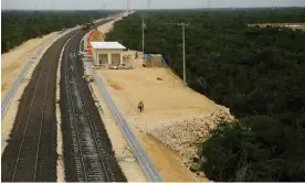  ?? Photograph: José Luis González/Reuters ?? Workers work on the constructi­on of a section of the Maya Train in Cancún, in the Mexican state of Quintana Roo on Tuesday.