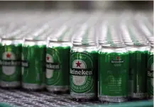  ?? (Paulo Whitaker/Reuters) ?? HEINEKEN BEERS are seen on a production line at the Heineken brewery in Jacarei, Brazil.