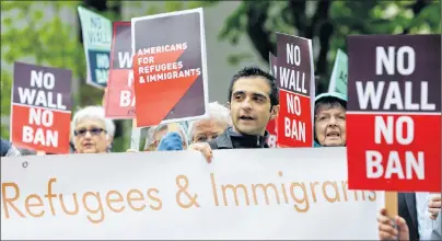  ?? AP PHOTO ?? Protesters hold signs during a demonstrat­ion against U.S. President Donald Trump’s revised travel ban, Monday, May 15, 2017, outside a federal courthouse in Seattle. Trump’s controvers­ial four-month worldwide ban on refugees ended Tuesday but new...