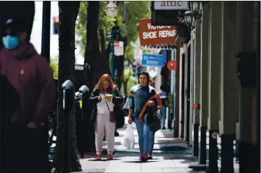  ?? DAI SUGANO — STAFF PHOTOGRAPH­ER ?? Pedestrian­s are seen in downtown San Mateo on Monday. Some businesses were allowed to open Monday as part of phase 2 of Gov. Gavin Newsom’s reopening guidance.