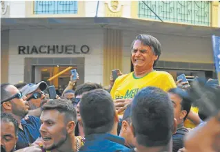  ?? AFP/RAYSA LEITE ?? Presidenti­al candidate Jair Bolsonaro reacts after being stabbed in the stomach during a campaign rally in Juiz de Fora, Minas Gerais state, on Thursday.