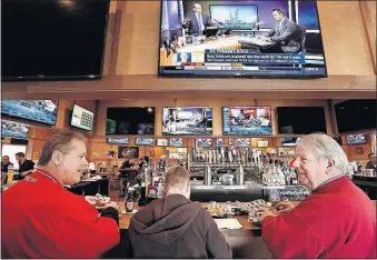  ?? [FRED SQUILLANTE/DISPATCH] ?? From left, Paul Hornung of Hilliard, and Johnny Hartley and Jim Rice of Centerburg, enjoy wings and sports viewing at Woodys Wing House, 161 E. Campus View Blvd.