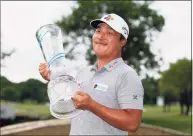  ?? Ray Carlin / Associated Press ?? Kyoung-Hoon Lee holds the trophy on the 18th green after winning the AT&T Byron Nelson on Sunday.