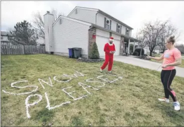  ?? COURTNEY HERGESHEIM­ER PHOTOS / COLUMBUS DISPATCH ?? Alan Rill, directed by his wife, Jen Kaperak, poses for a few ‘Elf on the Shelf” photos at their Hilliard home, to keep up with their daily social media posts.