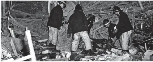  ??  ?? Scene of carnage: Firemen sift through the wreckage of one of the pubs blown up in Birmingham city centre in 197