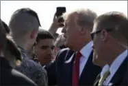  ?? SUSAN WALSH ?? President Donald Trump greets troops at Elmendorf Air Force Base in Anchorage, Alaska, Wednesday, June 26, 2019, during a refueling stop. Trump is heading to the G-20 in Japan, his third overseas trip in a month facing a flurry of internatio­nal crises, tense negotiatio­ns and a growing global to-do list.