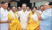  ?? PTI PHOTO ?? DMK working president MK Stalin presents a shawl to his sister and Rajya Sabha MP Kanimozhi and party colleague A Raja at the Chennai airport on Saturday.