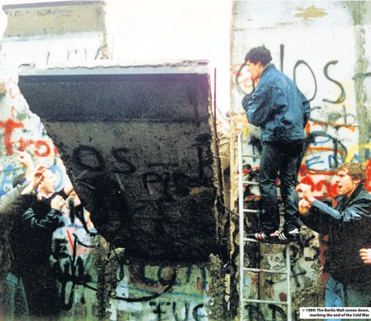  ??  ?? > 1989: The Berlin Wall comes down, marking the end of the Cold War