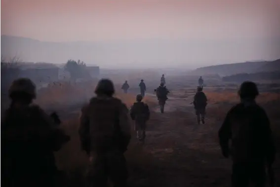  ??  ?? FILE - In this Dec. 23, 2009, file photo United States Marines from the 2nd Battalion 2nd Marines “Warlords” and Afghan National Army soldiers walk in formation during an operation in the Garmsir district of the volatile Helmand province, southern Afghanista­n. (AP Photo/Kevin Frayer, File)