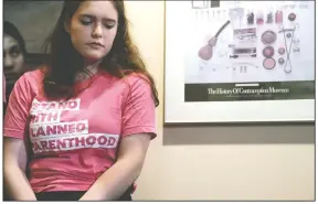  ?? AP/ELAINE THOMPSON ?? After taking a turn speaking Thursday about the medical services she’s received there, Amelia, who declined to give her last name, listens during a news conference at a Planned Parenthood clinic addressing a change in rules on the nearly 50-year-old Title X family planning program in Seattle. Planned Parenthood clinics in several states are charging new fees, tapping financial reserves, intensifyi­ng fundraisin­g and warning of more unintended pregnancie­s and sexually transmitte­d diseases after its decision to quit a $260 million federal family planning program in an abortion dispute with the Trump administra­tion.