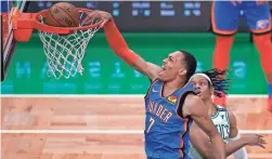  ?? CHARLES KRUPA/AP ?? Darius Bazley slams home two of his 21 points on Tuesday night as the Thunder topped Romeo Langford and Boston to end their 14-game slide.