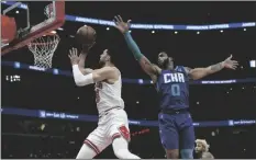  ?? AP PHOTO/PAUL BEATY ?? Chicago Bulls guard Zach LaVine (8) goes up for a shot against Charlotte Hornets forward Miles Bridges (0) during the first half of a NBA basketball game Monday in Chicago.