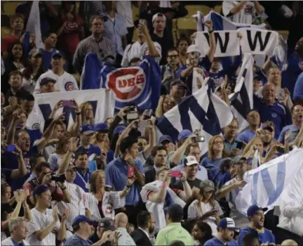  ?? JAE C. HONG — ASSOCIATED PRESS ?? Cubs fans celebrate in Dodger Stadium after the team’s 8-4 win in Game 5 of the National League Championsh­ip Series in Los Angeles on Thursday night.