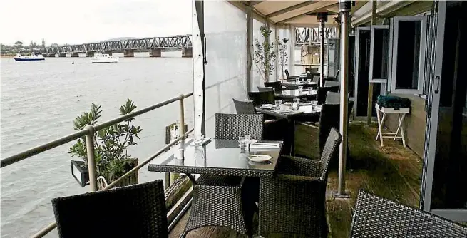  ??  ?? The over-water dining balcony at Harboursid­e gifts views out to Tauranga Harbour, and the old railway bridge.