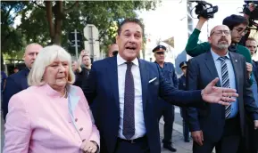  ?? (Leonhard Foeger/Reuters) ?? HEINZ-CHRISTIAN STRACHE, an Austrian candidate and head of the far-right Freedom Party, and his mother, Marion Strache, arrive at a polling station in Vienna yesterday.