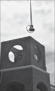  ??  ?? Project Manager Tom Duswalt of Rainbow Constructi­on oversees the historic bell’s installati­on last Tuesday at La Plata United Methodist Church.