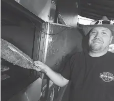  ?? DAX MELMER ?? Chris Bardoel of Big M’s Smokin’ Bones BBQ prepares ribs Thursday for this weekend’s Ribfest at the Riverfront Festival Plaza.