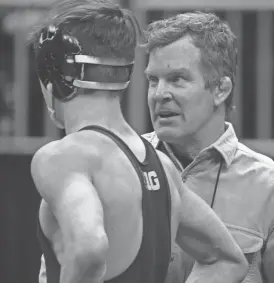  ?? ?? Iowa associate head coach Terry Brands speaks with Drake Ayala during Friday’s 125-pound semifinal round at the NCAA Wrestling Championsh­ips in Kansas City.