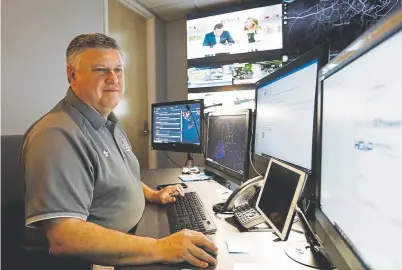  ?? Photos by Cody Jackson, The Associated Press ?? Paul Hildreth, emergency operations coordinato­r for the Fulton County School District, works in the emergency operations center at the district’s Administra­tion Center in Atlanta in July. Hildreth’s Atlanta district will spend $16.5 million to put the cameras in its roughly 100 buildings in coming years.