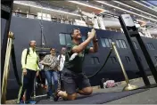  ?? HENG SINITH — THE ASSOCIATED PRESS FILE ?? John Miller, from Orcas Island, Wash., reacts after he disembarke­d from the MS Westerdam, back, at the port of Sihanoukvi­lle, Cambodia.