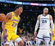  ?? JAE C. HONG/THE ASSOCIATED PRESS ?? The Lakers’ Rui Hachimura celebrates a dunk next to the Grizzlies’ Dillon Brooks on Friday in Game 6 of a first-round series Friday in Los Angeles. The Lakers blew out the Grizzlies 125-85 to advance to the second round.