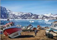  ?? REUTERS ?? A man walks to his boat past a number of abandoned boats in the town of Tasiilaq, Greenland, on 15 June 2018.