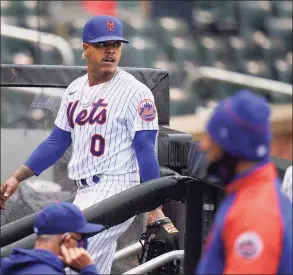 ?? Seth Wenig / Associated Press ?? Mets starting pitcher Marcus Stroman leaves the field at the start of a rain delay during the first inning against the Marlins on Sunday at Citi Field in New York.